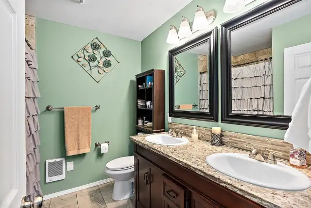 Remodeled main level full bath. Granite countertops, custom tile.