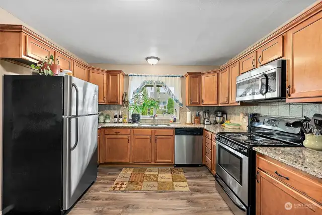 Updated kitchen with granite countertops, solid wood cabinetry and stainless steel appliances.