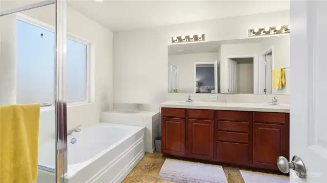 Primary bathroom features separate shower, soaking tub, double vanity & separate water closet.