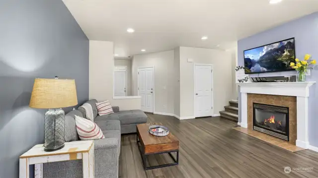 Living room remains subtly separate from the entry, boasting recessing light and modern architectural details.