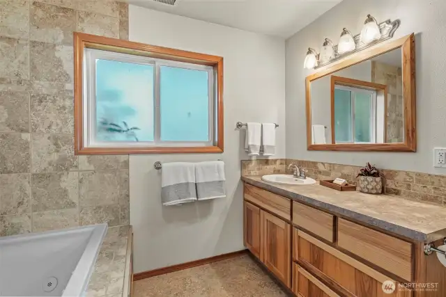 Full bath with jetted tub, comfort height vanity - beautiful cabinetry, tile surround & vinyl windows.