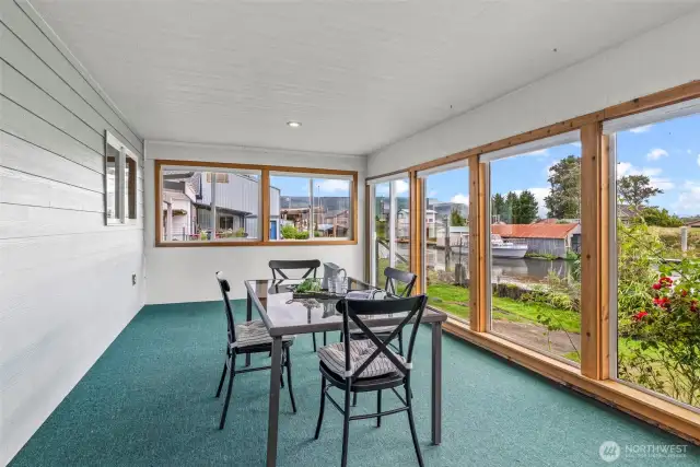 4-season room with water views, deck and access to fenced back yard.