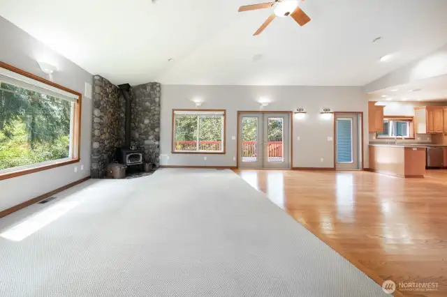 Open concept living and dining room with french doors to deck