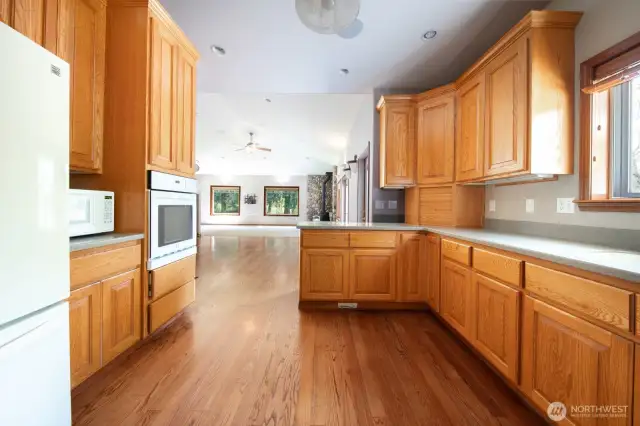 Cooks kitchen with great counter space and beautiful oak hardwood floors