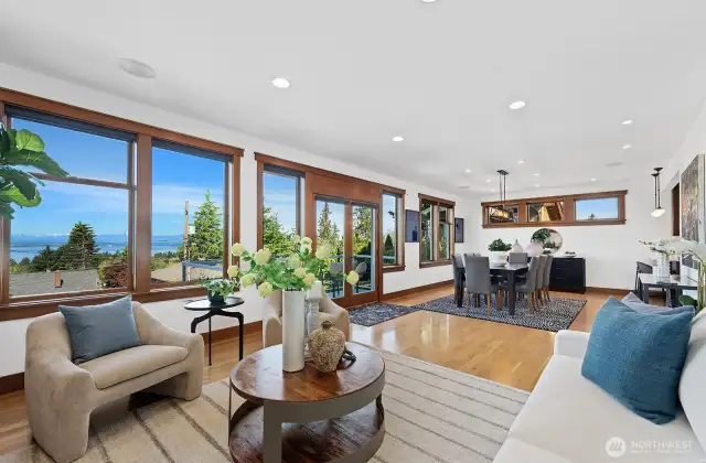 Living and dining room and it's wall of windows.