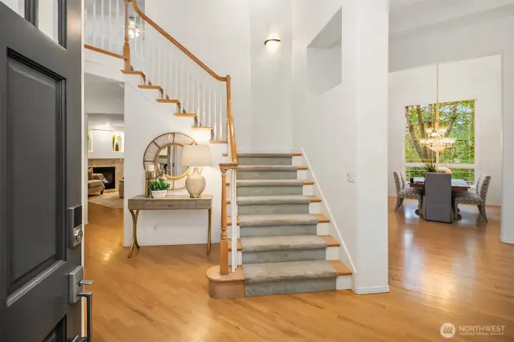 Step into elegance with the grand, signature staircase that defines the timeless style and superior craftsmanship of Wood River Homes.