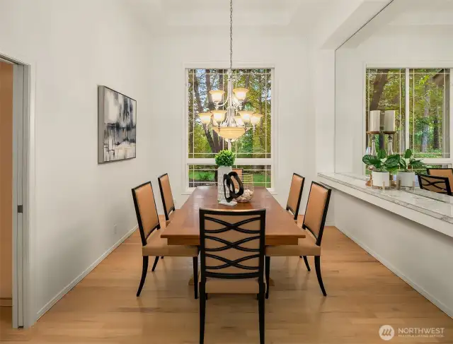 Formal dining with cantalevered ceilings and built in shelf