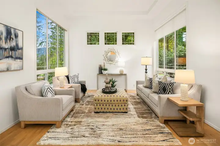 Step into a formal living room filled with sunshine, where high ceilings and tall windows create an open, airy ambiance perfect for relaxing or entertaining.
