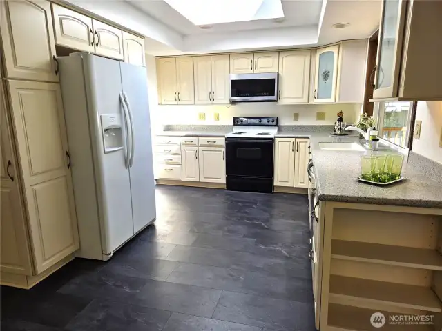 Pantry cabinet on this side of refrigerator