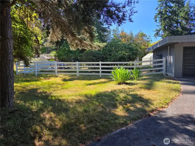 White vinyl fencing enclosed large yard.