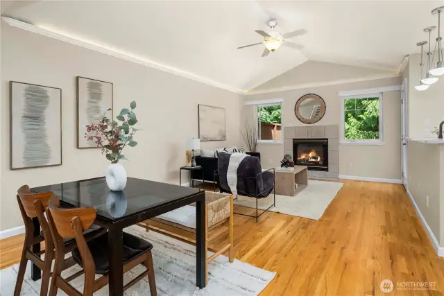 Vaulted ceilings and natural light enhance this open living and dining space