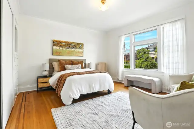 The bedroom includes warm, beautiful hardwood floors, and ample closet & storage space.