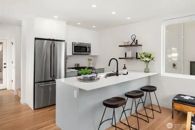 Open-concept kitchen, outfitted with premium appliances