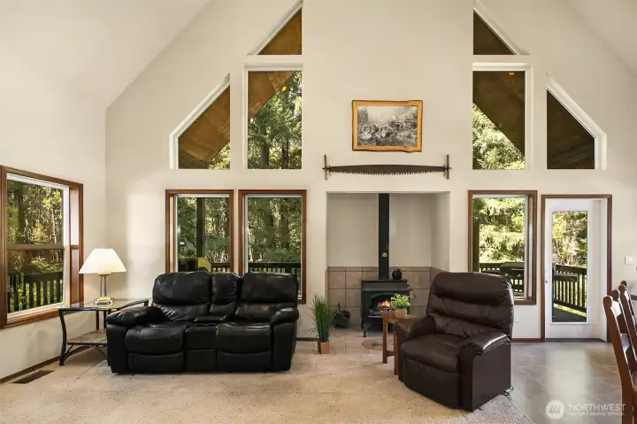Fabulous views out every window of towering evergreens and seasonal "Silver Creek". The soaring vaulted ceilings and numerous windows in this home bring in the beautiful outdoors with tons of ample natural light