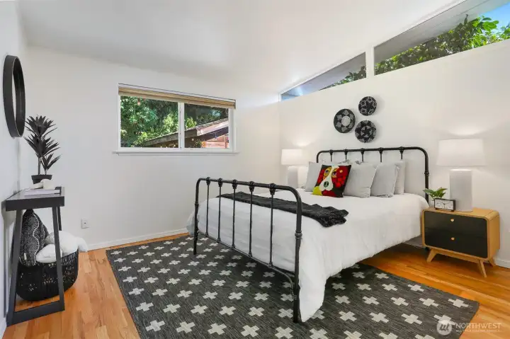 Primary bedroom with vaulted ceiling