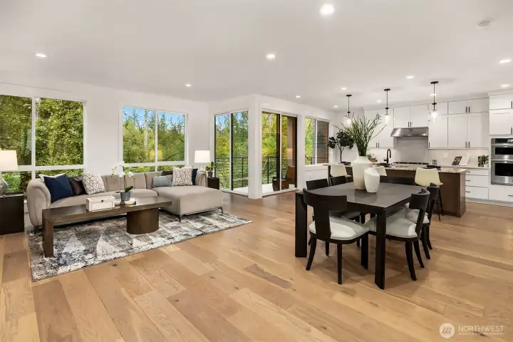 Great room is light and bright with expansive views of the nature preserve   Photos are for illustrative purposes only