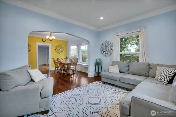 Large living room with gleaming hardwood flooring & great crown moldings!