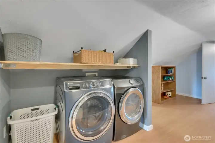 Wonderful laundry area with shelving & storage!