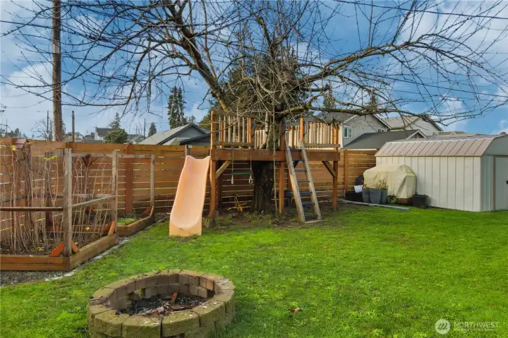 Check out this amazing tree house! Notice the storage shed as well.