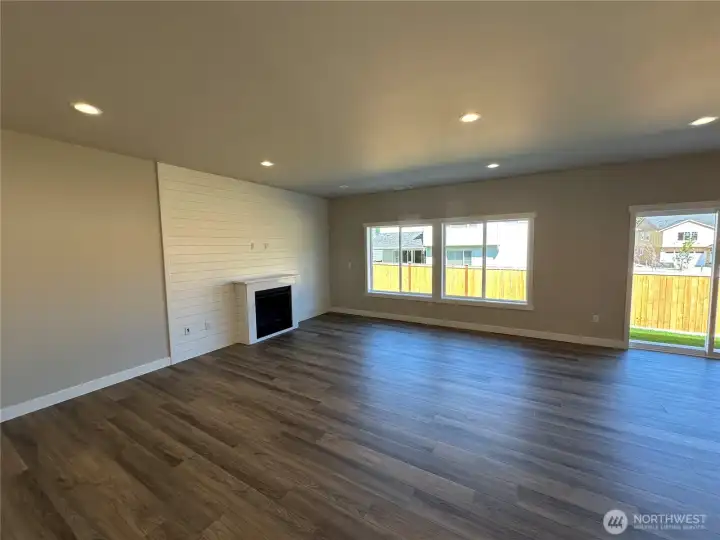 FOR ILLUSTRATION PURPOSES Family with gas fireplace, quartz mantel and LVP floors