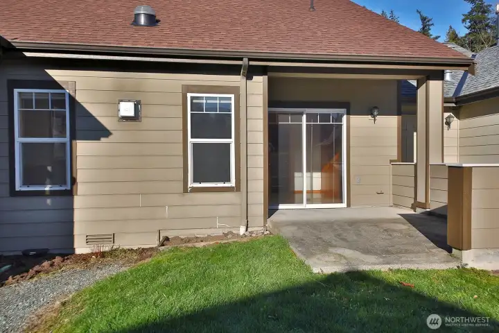 Covered back patio with man door and sliding glass door from Bedroom #2.