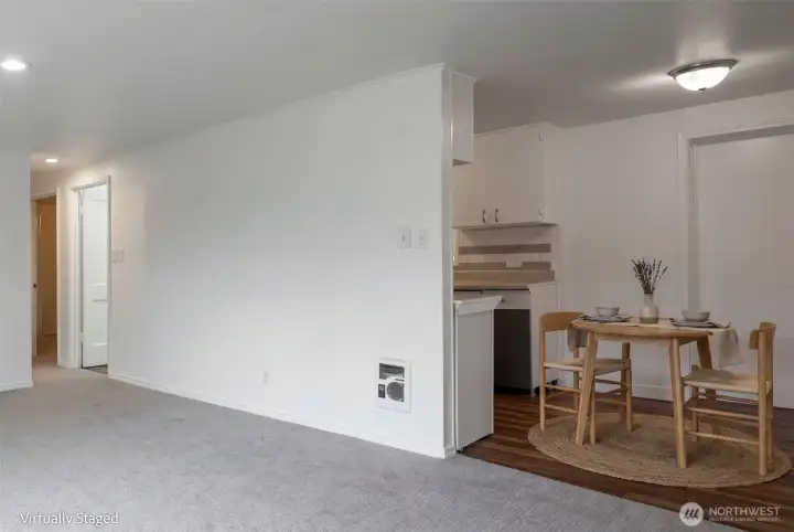 Open to the kitchen and dining space and a door to the garage.