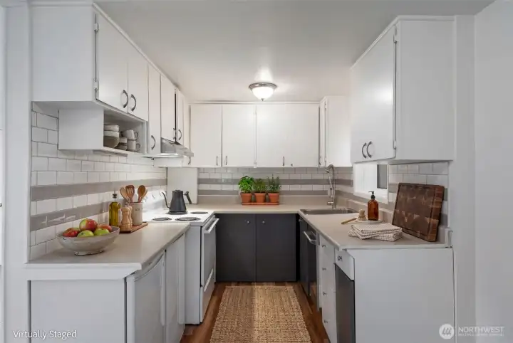 Efficient kitchen with lower level refrigerators, range and dishwashers.