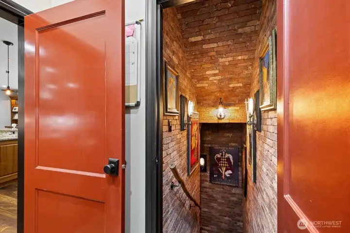 Enter onto the cobblestone floors off the kitchen and down the brick lined stairway where there lies a wine cellar shrouded in mystery and intrigue.  Upon entering, you are greeted by the cool air that carries the scent of aged oak.  The dim light from flickering candles illuminates rows upon rows of wine bottles, each one bearing tales of storied past.  It beckons to those who seek not just to taste, but to experience the magic that lies within each precious drop.