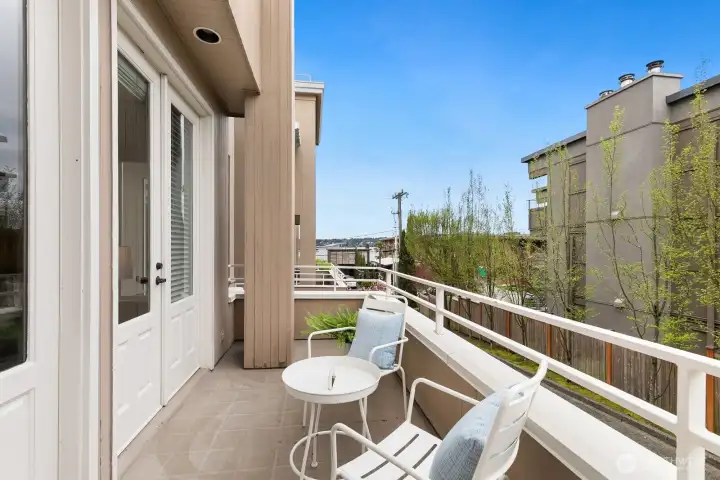 Indoor/outdoor entertaining flows seamlessly. Step out from the living room through elegant French doors onto a charming deck, where you can enjoy peaceful eastern views stretching across Lake Washington.
