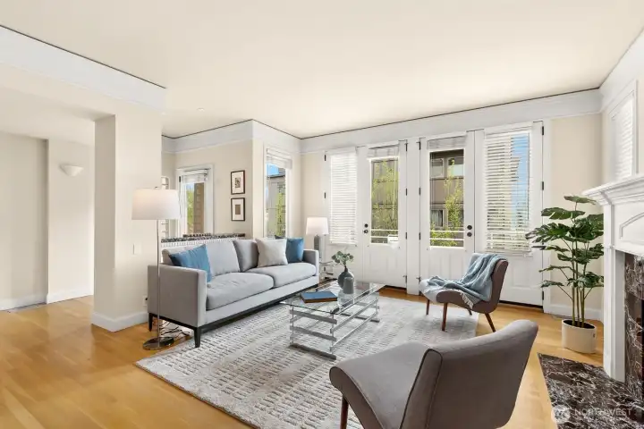 Spacious living room with south facing bank of windows and doors.