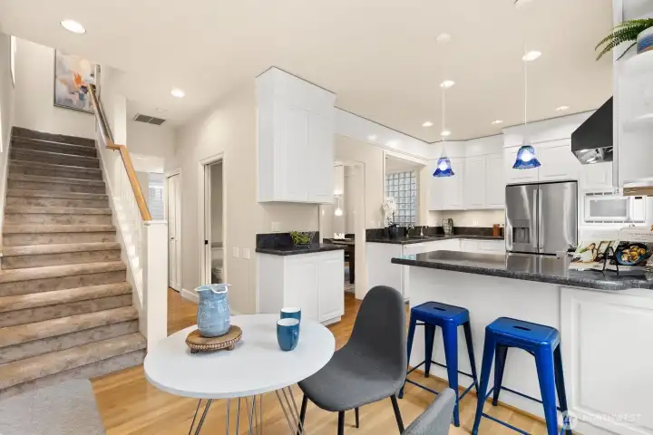 breakfast nook with corner windows also allows for a view to the upperlevel stairs.