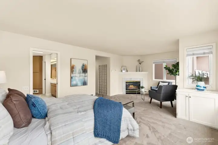 The spacious primary suite is a serene retreat with southern views and a cozy gas fireplace, and full ensuite bath.