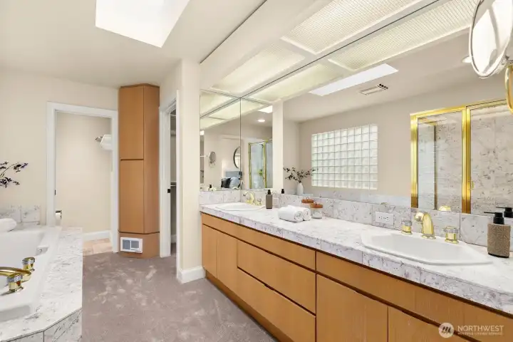 The spacious primary bathroom offers a luxurious escape, featuring a large shower, a relaxing soaking tub, and ample counter space—perfect for daily comfort and spa-like indulgence.