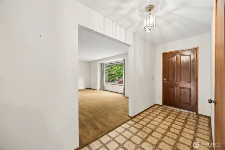 Step into a spacious entry with fun retro flooring that flows into two generous living spaces.