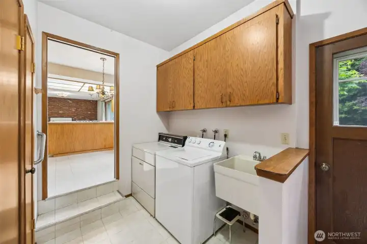 Utility room is conveniently located just off of the kitchen. This room also has access to the backyard, garage, basement and short hallway to a powder room & 4th bedroom.