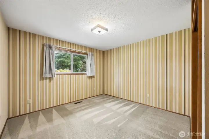 Bedroom #2 with freshly cleaned carpets, looks out over the beautiful front yard.