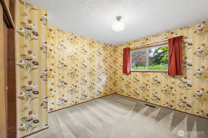 Fun and funky walls in bedroom #3, also looking out over the front yard. Both of these bedrooms have closets with - you guessed it - extra storage space above them!