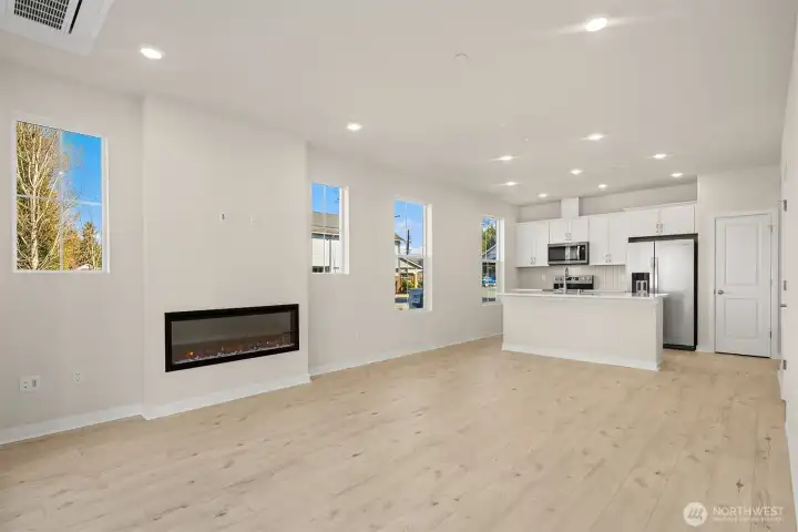 Gathering room with fireplace. Similar home shown.