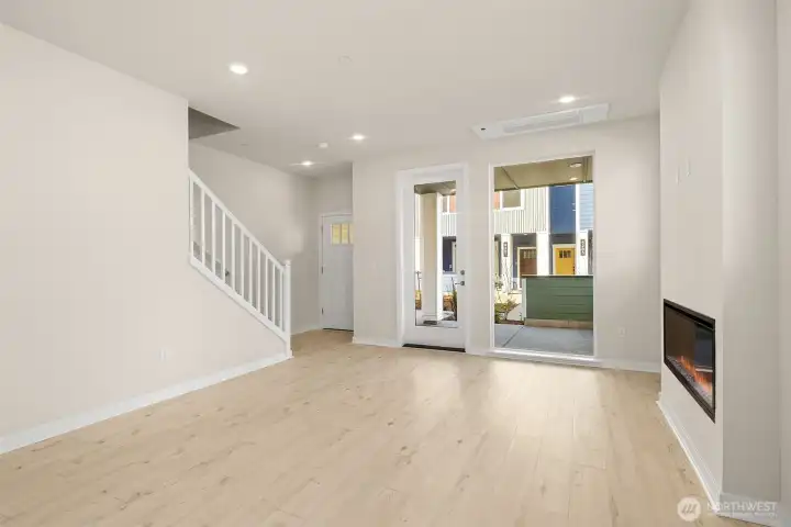 Gathering room, stairs, and covered patio. Similar home shown.