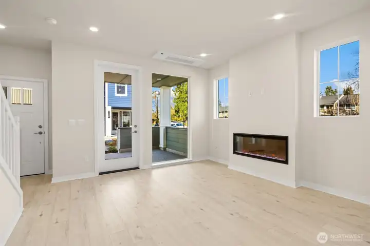 Gathering room with fireplace. Similar home shown.