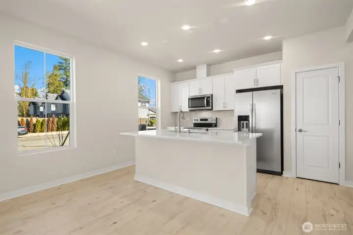 Kitchen with island. Similar home shown.