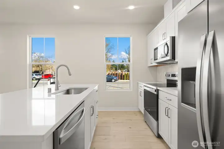 Kitchen with extra windows. Similar home shown.