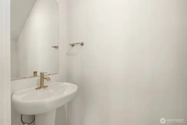 First floor powder room. Similar home shown.