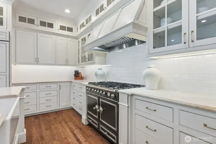 Showcasing a La Cornue gas range, Sub-Zero refrigeration and exquisite quartzite surfaces. Showcasing a La Cornue gas range, Sub-Zero refrigeration and exquisite quartzite surfaces.