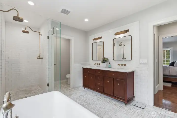 Spa-inspired Carrara marble bath adorned with European antique brass fixtures and heated marble floors. Spa-inspired Carrara marble bath adorned with European antique brass fixtures and heated marble floors.