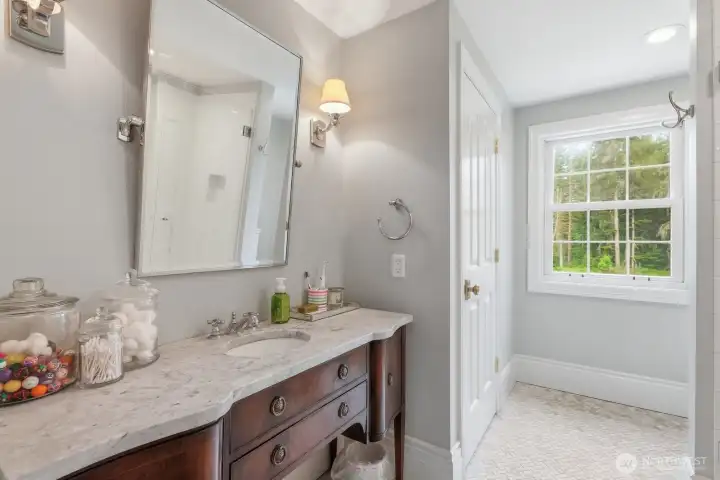 The 3/4 bathroom in this bedroom with marble vanity and floor, sconce lighting and linen closet. The 3/4 bathroom in this bedroom with marble vanity and floor, sconce lighting and linen closet.