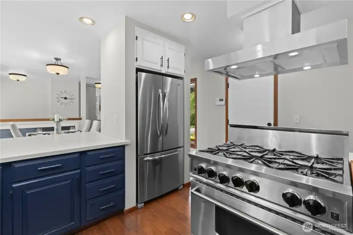 The chef will love the 6-burner gas range with hood vent.