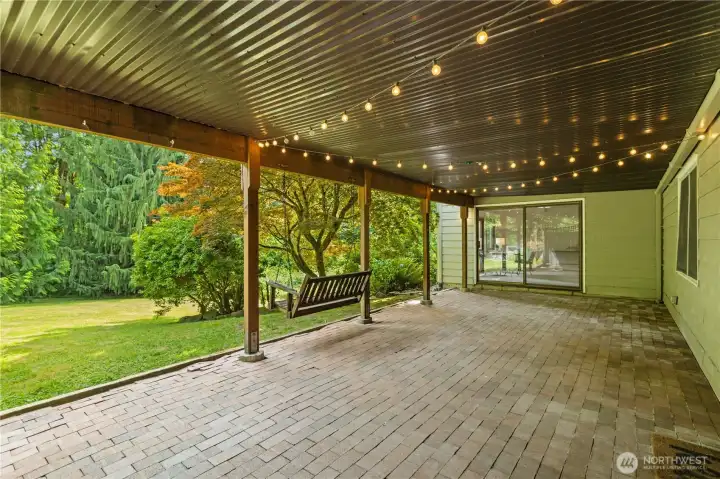 The covered patio sits below the deck for those rainy days.