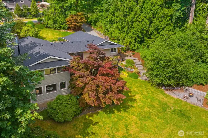 The .81 acre lot offers mature landscaping, privacy, a fire pit, and fruit trees!
