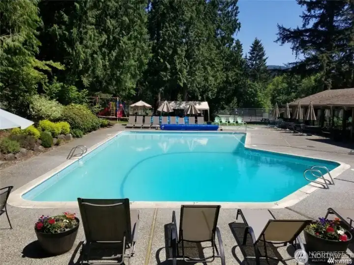 The Club includes a heated pool and hot tub, a playground, clubhouse, pea patch, tennis courts, and trails.